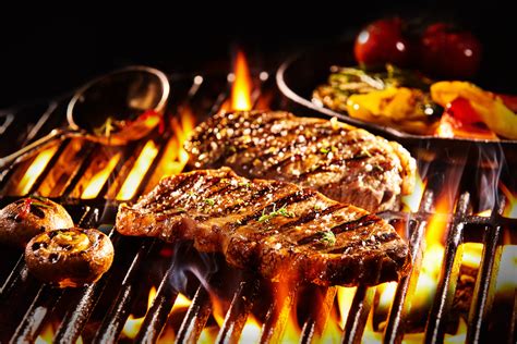 cooking steak on bbq grill
